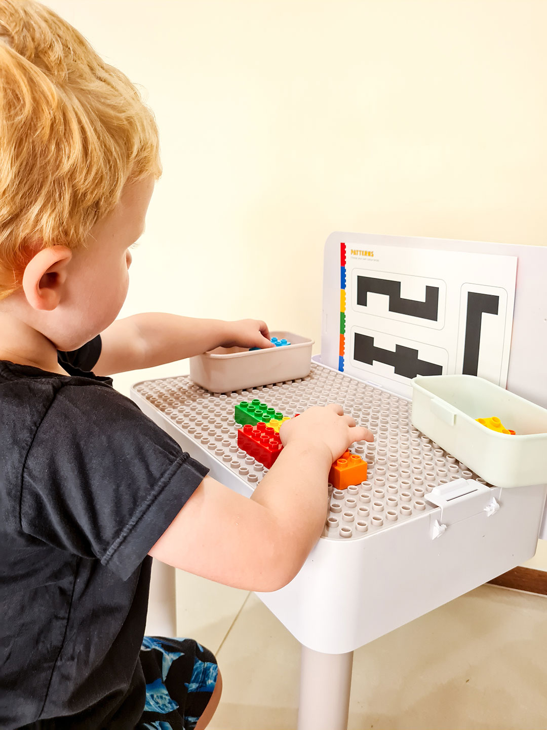 A collection of Six Bricks learning tools including mats, cards, and a storage box.