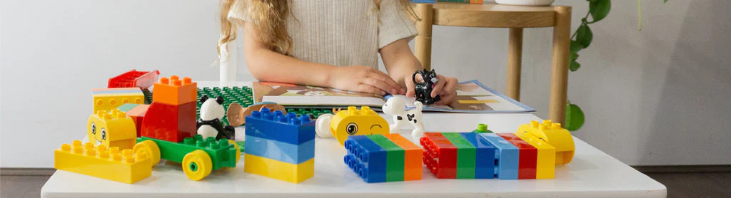 A child happily playing with colorful building blocks, away from screens.